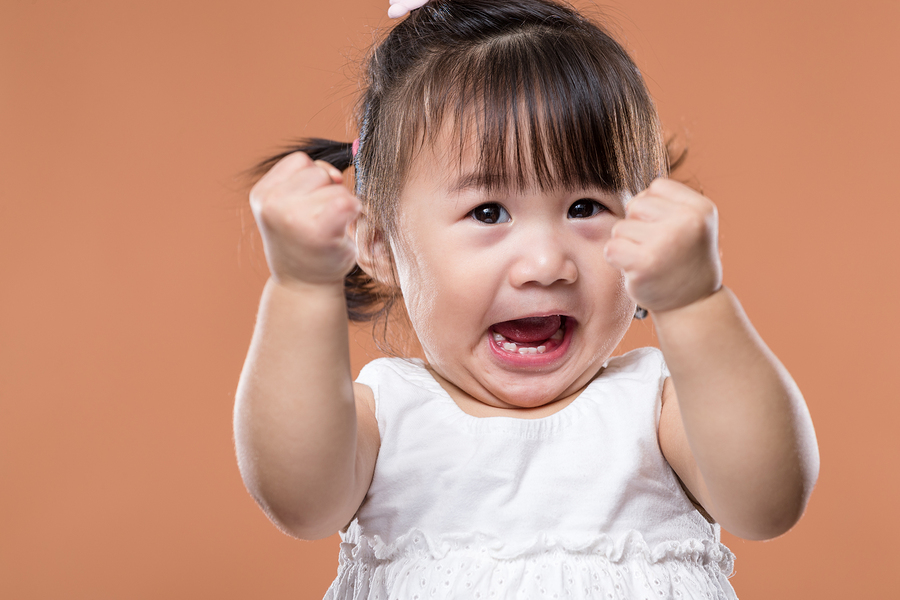 Excited Baby Girl Holding Arm Fist