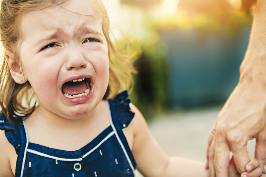 Close Up Portrait Of Crying Little Toddler Girl With Outdoors Ba